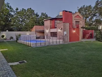 a house with a pool in the yard at Las Cuatro Estaciones in Villa Cura Brochero