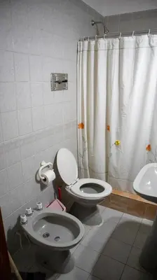 a bathroom with a toilet and a sink at Bungalows Punta Azul in Villa Carlos Paz