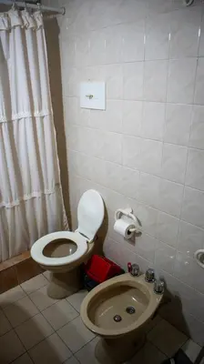 a bathroom with a toilet and a sink at Bungalows Punta Azul in Villa Carlos Paz