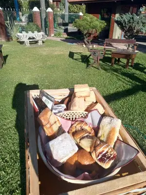 a tray of bread and pastries on a table at Bungalows Punta Azul in Villa Carlos Paz