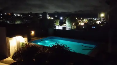 a view of a swimming pool at night at Los Ceibos in Villa Carlos Paz