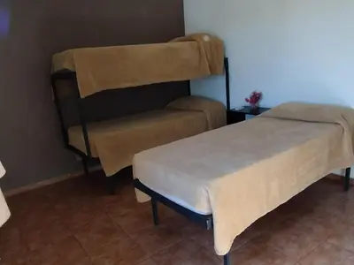 two beds in a small room with aermottermott at Los Ceibos in Villa Carlos Paz