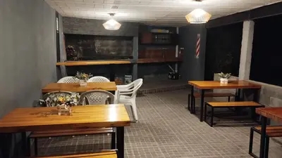 a dining room with wooden tables and white chairs at Los Ceibos in Villa Carlos Paz