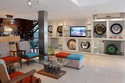 a lobby with a tv and chairs and a table at Hotel Capvio in Villa Carlos Paz