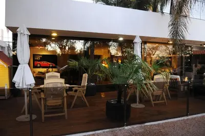 a restaurant with a table and chairs in a window at Hotel Capvio in Villa Carlos Paz