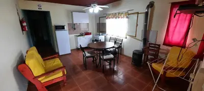 a kitchen and dining room with a table and chairs at Montañas Del Sol in Santa Rosa de Calamuchita