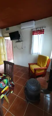 a living room with a couch and a tv in a room at Montañas Del Sol in Santa Rosa de Calamuchita