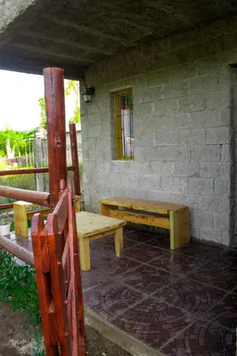 a bench sitting outside of a building with a window at Montañas Del Sol in Santa Rosa de Calamuchita