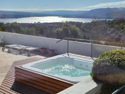 a hot tub sitting on top of a patio at Le Mirage Village Club Resort in Villa Carlos Paz