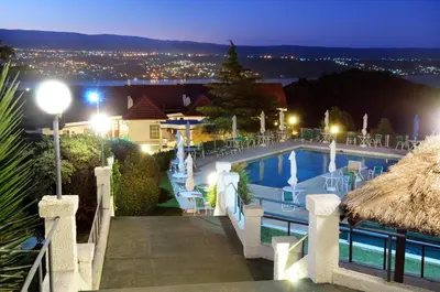 a view of a swimming pool at night at Le Mirage Village Club Resort in Villa Carlos Paz