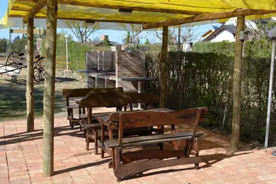 a group of benches sitting under a gazebo at Atahualpa mi Posada in Mina Clavero