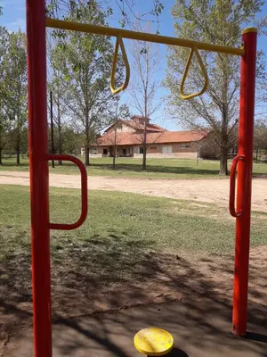 a red bus stop with a yellow hat in a park at Atahualpa mi Posada in Mina Clavero