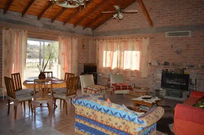 a living room filled with furniture and a fireplace at Atahualpa mi Posada in Mina Clavero