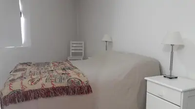 a bedroom with a bed and a dresser and lamps at Espacio C Ambrosio Olmos in Cordoba