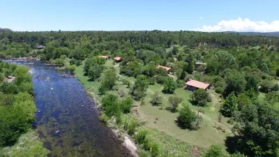 an aerial view of a river and a village at El Rodeo Apart Cabañas in Santa Rosa de Calamuchita