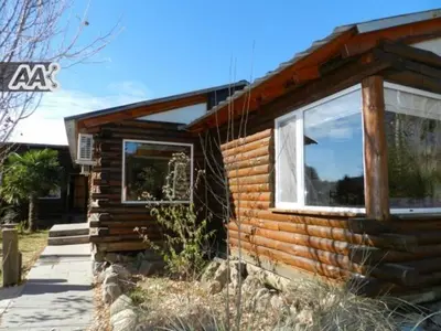 a log cabin with a window on the side of it at El Rodeo Apart Cabañas in Santa Rosa de Calamuchita