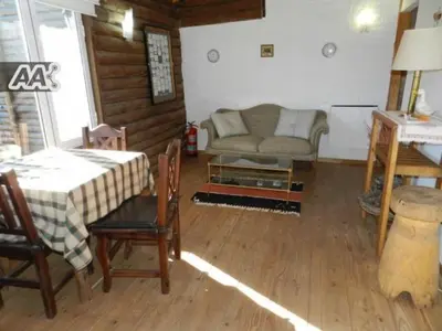 a living room with a couch and a table at El Rodeo Apart Cabañas in Santa Rosa de Calamuchita