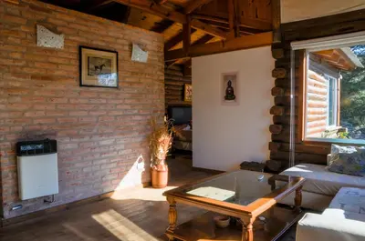a living room with a brick wall at El Rodeo Apart Cabañas in Santa Rosa de Calamuchita