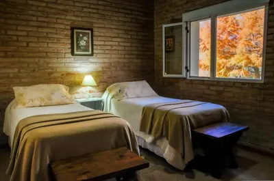 a room with two beds and a window at El Rodeo Apart Cabañas in Santa Rosa de Calamuchita
