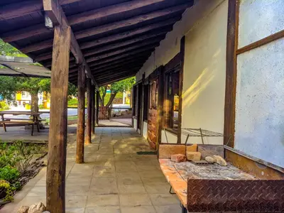 a porch of a building with a wooden roof at La Casita Alquiler Temporario in Merlo
