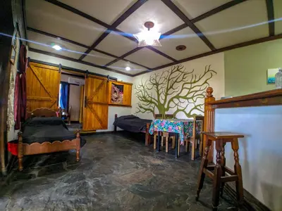 a living room with a table and chairs in it at La Casita Alquiler Temporario in Merlo