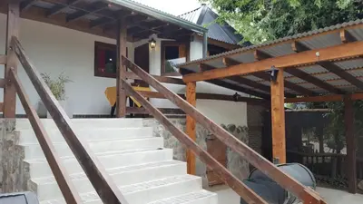 a staircase leading to a house with a wooden roof at Magma Village in Los Reartes