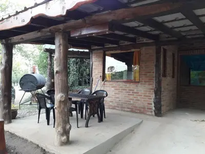 a patio with a table and chairs under a brick building at Magma Village in Los Reartes