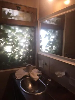 a bathroom with a sink and a fishtank in a window at Magma Village in Los Reartes