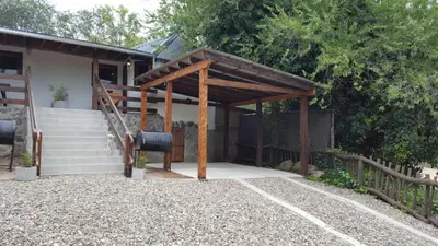 a house with a wooden pergola next to some stairs at Magma Village in Los Reartes