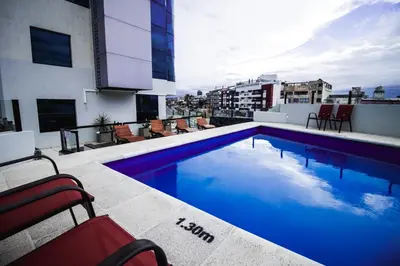 a swimming pool on the roof of a building at Apart Riviera Tower Suites in Villa Carlos Paz