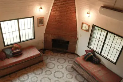 a living room with two couches and a fireplace at Vista del sol in Villa Ciudad Parque