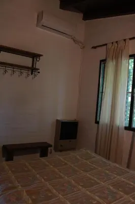 a bedroom with a bed and a tv in it at Vista del sol in Villa Ciudad Parque