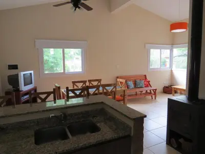a kitchen with a sink and a living room at Casa en Villa Los Aromos in La Bolsa