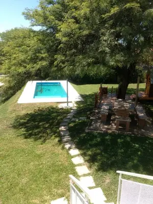 a swimming pool in a yard with a tree at Casa en Villa Los Aromos in La Bolsa