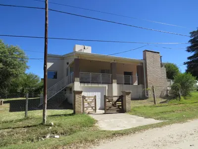 a house with a gate in front of it at Casa en Villa Los Aromos in La Bolsa