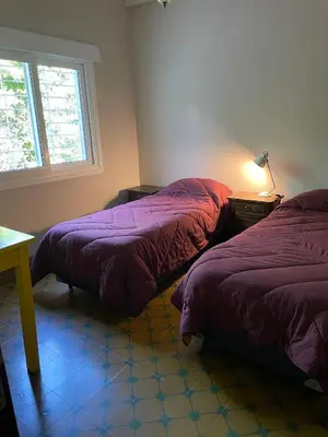 a bedroom with two beds and a window at La Elina in Villa General Belgrano