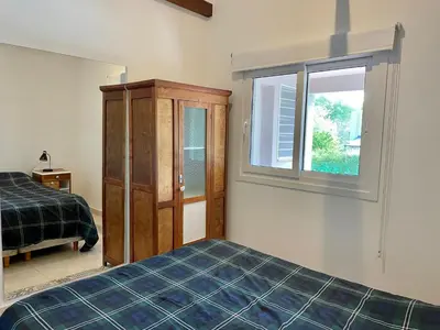 a bedroom with a bed and a window at La Elina in Villa General Belgrano