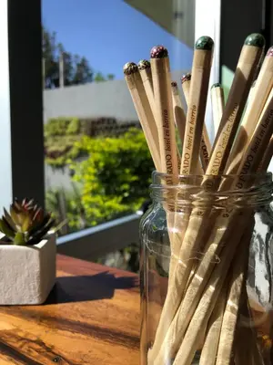 a glass jar filled with wooden sticks on a table at Ciudad Prado Hotel in Cordoba