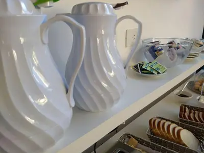 two large white vases sitting on a shelf at Ciudad Prado Hotel in Cordoba