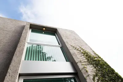 a window of a building with a plant at Ciudad Prado Hotel in Cordoba