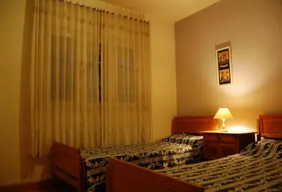 a hotel room with two beds and a window at Casa Monty in Mina Clavero