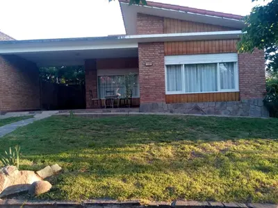 a house with a lawn in front of it at Casa Monty in Mina Clavero