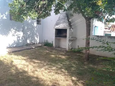 an oven in the side of a white building with a tree at Casa Monty in Mina Clavero
