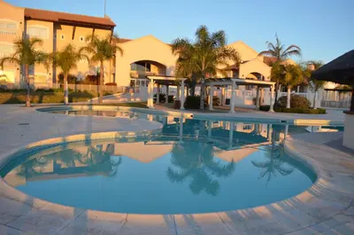 a large swimming pool in front of a building at Howard Johnson Resort Spa & Convention Center in Merlo