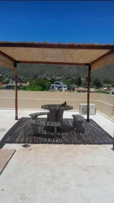a picnic table and chairs under a pavilion at Departamento de alquiler temporario in Villa Carlos Paz