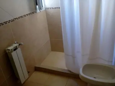 a bathroom with a shower with a toilet and a shower curtain at Departamento de alquiler temporario in Villa Carlos Paz