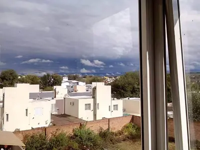 a view of a white city from a window at Departamento de alquiler temporario in Villa Carlos Paz
