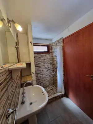 a bathroom with a sink and a shower at Apartamentos Andrea in Villa General Belgrano
