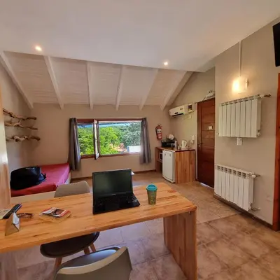 a room with a desk with a laptop on it at Apartamentos Andrea in Villa General Belgrano