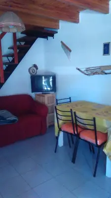 a living room with a table and a couch at Departamento carlos paz in Villa Carlos Paz